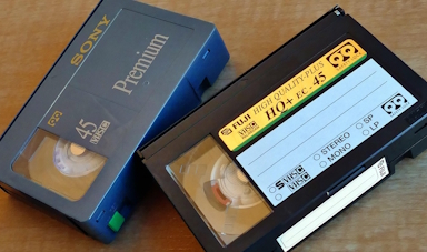 Moving picture of person inserting vhs tape into vcr